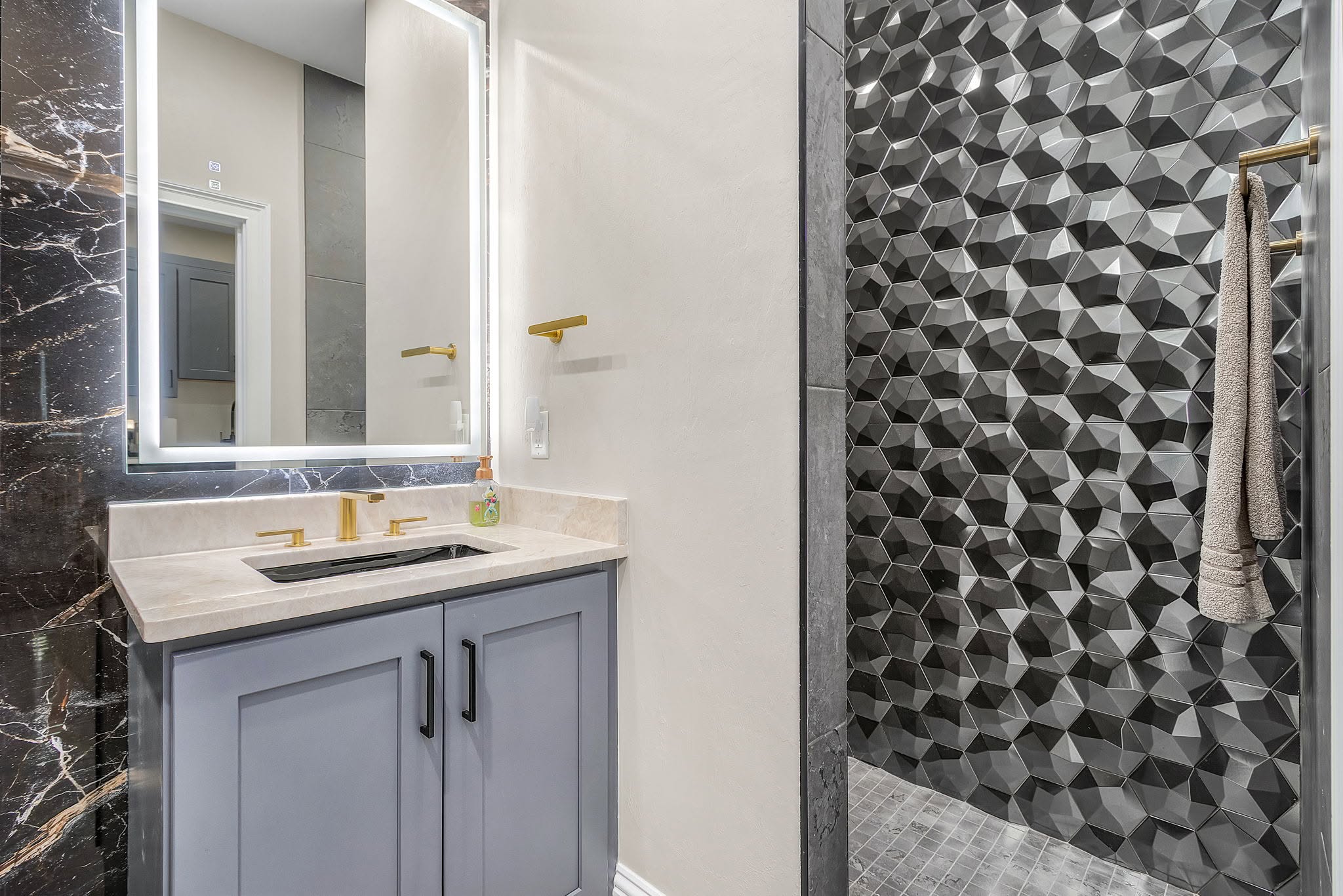 Completed geometric tile bathroom by Proskillz Remodeling