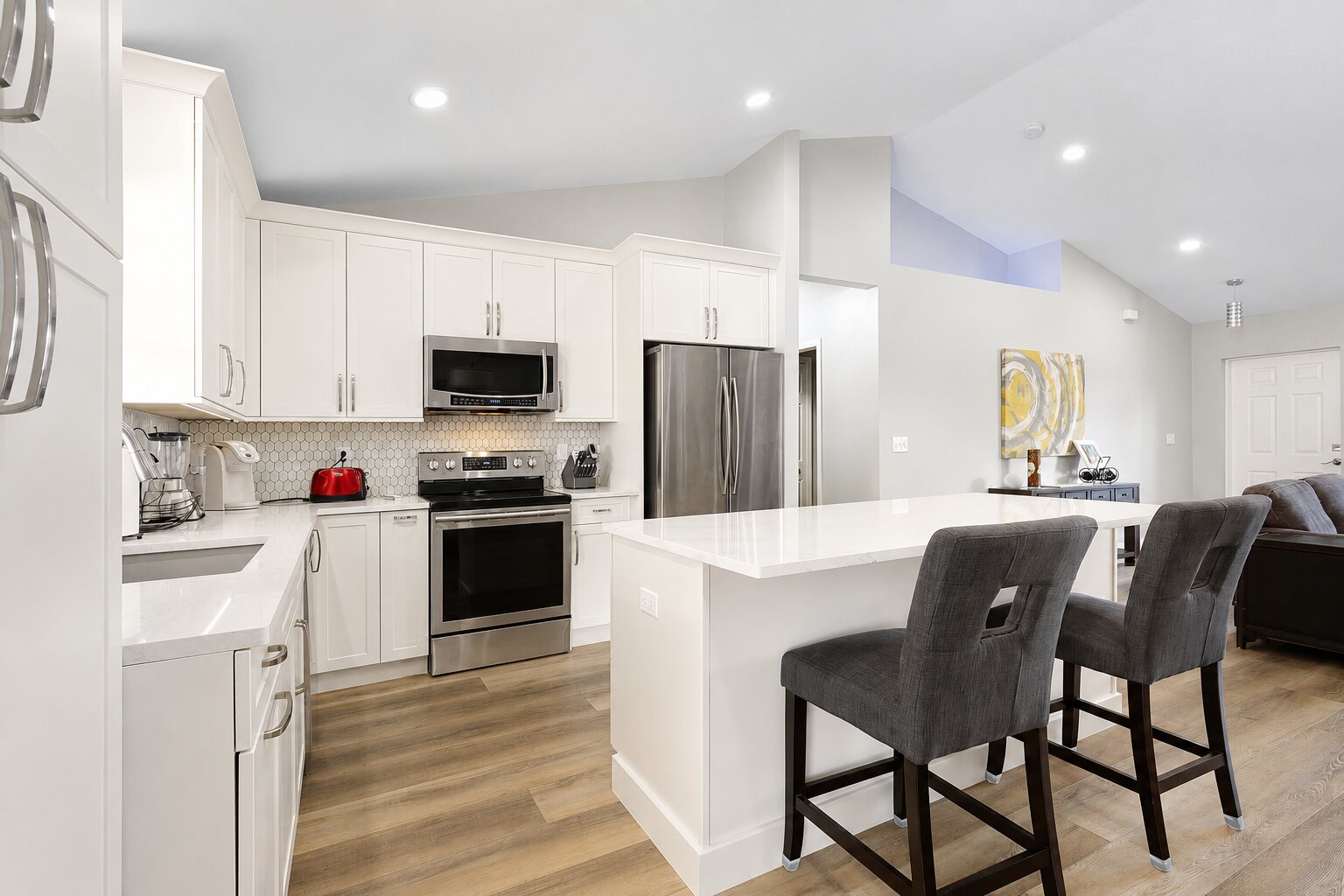 Completed bright kitchen renovation connected to the surrounding living area by Proskillz Remodeling