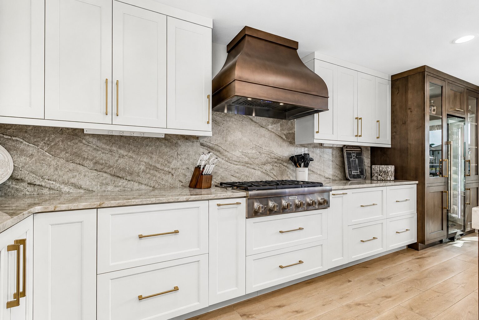 Completed kitchen transformation with coordinated surfaces, lighting and architectural details by Proskillz Remodeling