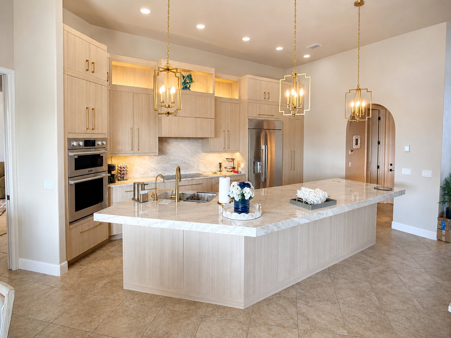 Completed kitchen renovation with a spacious island and warm lighting by Proskillz Remodeling