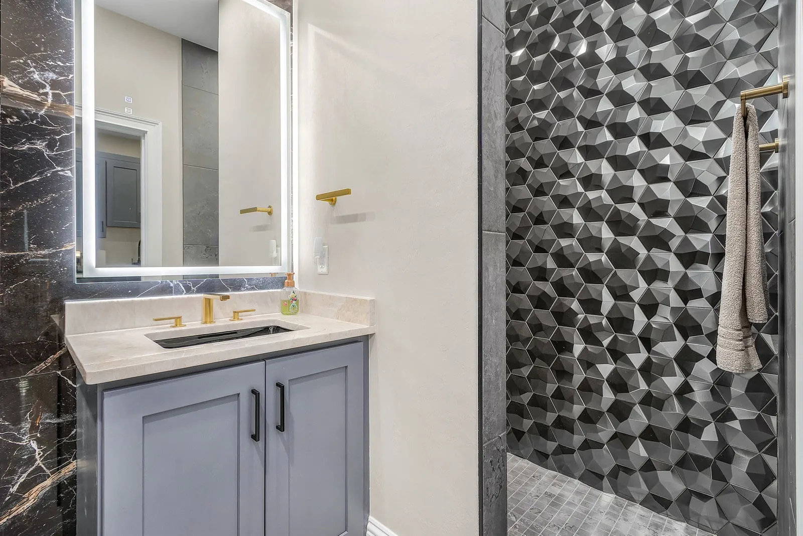 Real Proskillz bathroom renovation with geometric tile and a floating vanity