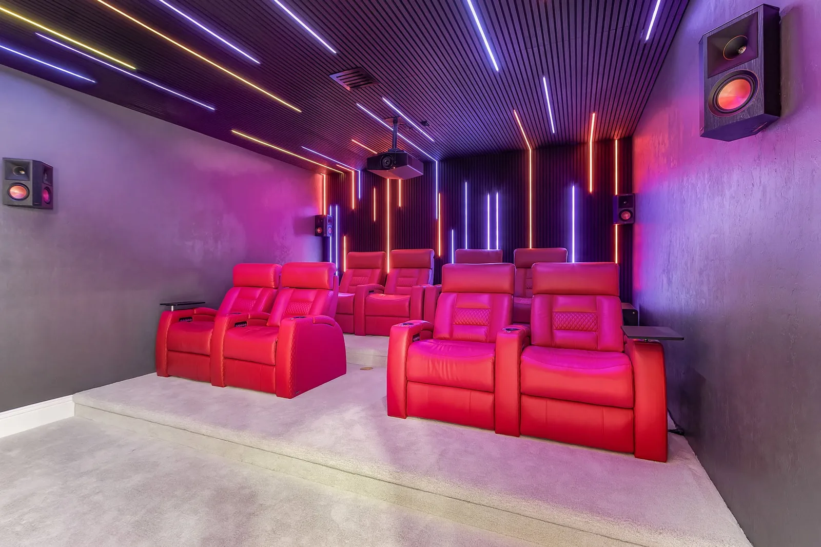 Completed home theater renovation with tiered seating and integrated lighting by Proskillz Remodeling